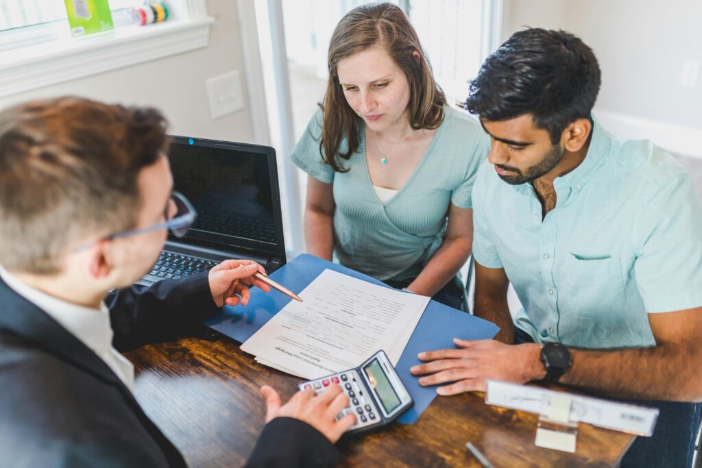 pexels-photo-8293651-8293651 Young couple meeting with real estate agent to discuss property purchase.